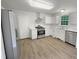 Modern kitchen featuring stainless steel appliances and white cabinetry at 517 Hidden Cellars Dr, Holly Springs, NC 27540