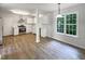 Open kitchen layout with white cabinets and stainless steel appliances at 517 Hidden Cellars Dr, Holly Springs, NC 27540