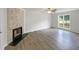 Large living room with a stone fireplace and a bright window at 517 Hidden Cellars Dr, Holly Springs, NC 27540