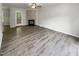 A bright living room with a cozy fireplace, neutral walls, and durable flooring at 517 Hidden Cellars Dr, Holly Springs, NC 27540