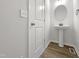 Modern powder room featuring a pedestal sink and updated lighting at 517 Hidden Cellars Dr, Holly Springs, NC 27540