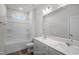 Modern bathroom featuring double sinks, a large mirror, and a tub with shower at 545 Beacon Hill Rd # 32, Lillington, NC 27546