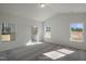 A bright carpeted bedroom with plenty of natural light and an ensuite bathroom at 545 Beacon Hill Rd # 32, Lillington, NC 27546