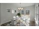 Bright dining room with modern chandelier, wood floors, and large windows providing plenty of natural light at 545 Beacon Hill Rd # 32, Lillington, NC 27546