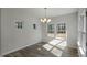 A bright dining room with modern chandelier and a view of the yard at 545 Beacon Hill Rd # 32, Lillington, NC 27546