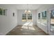 A dining room with wood floors and large windows that provide view of the outside at 545 Beacon Hill Rd # 32, Lillington, NC 27546