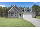 Beautiful gray home with dormer windows, two-car garage, and a spacious lawn at 545 Beacon Hill Rd # 32, Lillington, NC 27546