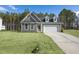 Inviting gray home with dormer windows, two-car garage, and well-maintained front yard at 545 Beacon Hill Rd # 32, Lillington, NC 27546
