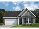 Charming single-story home featuring gray siding, a two-car garage, and a well-manicured lawn at 545 Beacon Hill Rd # 32, Lillington, NC 27546
