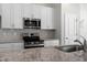 Granite countertops and stainless appliances highlight the modern kitchen design at 545 Beacon Hill Rd # 32, Lillington, NC 27546