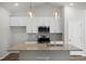 Bright kitchen with a stone countertop island, stainless steel appliances, and pendant lighting at 545 Beacon Hill Rd # 32, Lillington, NC 27546
