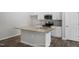 Modern kitchen featuring a stone countertop island and a stainless steel appliance package at 545 Beacon Hill Rd # 32, Lillington, NC 27546