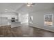 Open-concept living area with kitchen, wood floors, and lots of natural light at 545 Beacon Hill Rd # 32, Lillington, NC 27546