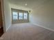 Spacious bedroom featuring plush carpet, large windows, and ample natural light for a serene and comfortable atmosphere at 604 Hyperion Aly, Wake Forest, NC 27587