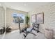 Exercise room with an elliptical trainer, weight bench, and natural light from the window at 604 Hyperion Aly, Wake Forest, NC 27587
