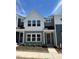 Charming two-story townhome featuring neutral-toned siding and a well-manicured lawn, perfect for comfortable living at 604 Hyperion Aly, Wake Forest, NC 27587