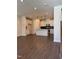 Open concept living room and kitchen featuring modern lighting, sleek floors, and a functional kitchen island at 604 Hyperion Aly, Wake Forest, NC 27587