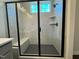 Glass-enclosed shower with tiled walls, a built-in bench, a window, and modern fixtures at 604 Hyperion Aly, Wake Forest, NC 27587