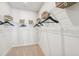 Bright walk-in closet with carpeted floor and white wire shelving with baskets at 604 Hyperion Aly, Wake Forest, NC 27587