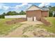 Backyard with a two-car garage, storage space, and well-kept lawn at 6042 Elliott Bridge Rd, Linden, NC 28356