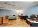 Basement bedroom and seating area with light blue walls and wood-look floors at 6042 Elliott Bridge Rd, Linden, NC 28356