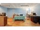 Basement bedroom with blue walls, desk area, and wood-look floors at 6042 Elliott Bridge Rd, Linden, NC 28356