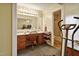 Bathroom featuring a double sink vanity with a chair and a connecting shower room at 6042 Elliott Bridge Rd, Linden, NC 28356