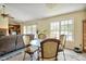 Cozy dining area with glass table, decorative chairs, and ample natural light from surrounding windows and doors at 6042 Elliott Bridge Rd, Linden, NC 28356