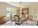 Charming dining area with a glass table, four chairs, and a decorative china cabinet for storage and display at 6042 Elliott Bridge Rd, Linden, NC 28356