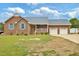 Charming single-story brick home featuring a manicured front lawn and attached garage at 6042 Elliott Bridge Rd, Linden, NC 28356