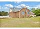 Brick house featuring a well-manicured lawn and a driveway leading to a two-car garage at 6042 Elliott Bridge Rd, Linden, NC 28356