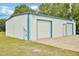 Spacious white garage with two large roll-up doors and ample parking space for multiple vehicles at 6042 Elliott Bridge Rd, Linden, NC 28356