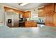 Spacious kitchen with stainless steel appliances, including a side-by-side refrigerator and oak wood cabinets at 6042 Elliott Bridge Rd, Linden, NC 28356