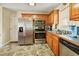 Updated kitchen with stainless steel appliances and oak cabinetry offers a practical space for culinary endeavors at 6042 Elliott Bridge Rd, Linden, NC 28356