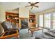 Comfortable living room featuring a fireplace, custom built-in shelving, and sliding doors to the outdoor area at 6042 Elliott Bridge Rd, Linden, NC 28356