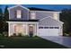 Charming two-story home with gray siding, a two-car garage, and a welcoming front porch at 641 White Birch Ln, Angier, NC 27501