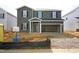 New construction two-story home with gray siding, black shutters and an unfinished front yard at 641 White Birch Ln, Angier, NC 27501