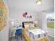 A vibrant bedroom with a playful theme, featuring a desk, a comfortable bed, and ample natural light at 659 White Birch Ln, Angier, NC 27501
