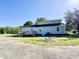 The backyard features the home with a deck and a gravel drive at 668 Surl Mount Tirzah Rd, Timberlake, NC 27583