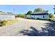 The back of the home features a gravel driveway, a deck, and a detached garage at 668 Surl Mount Tirzah Rd, Timberlake, NC 27583