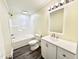 Bathroom featuring a shower-tub combo, modern vanity with stainless hardware, and sleek hardwood floors at 668 Surl Mount Tirzah Rd, Timberlake, NC 27583