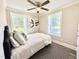 Comfortable bedroom with stylish décor, natural light, and a striped rug accenting the floors at 668 Surl Mount Tirzah Rd, Timberlake, NC 27583