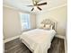 Bright bedroom with a cushioned headboard, wood-look floors, and a window for natural light at 668 Surl Mount Tirzah Rd, Timberlake, NC 27583