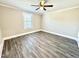 Spacious bedroom with wood-look floors, ceiling fan and large window for natural light at 668 Surl Mount Tirzah Rd, Timberlake, NC 27583