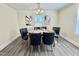 Bright dining room with modern light fixture and two large windows at 668 Surl Mount Tirzah Rd, Timberlake, NC 27583