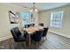 Elegant dining room with modern chandelier, stylish chairs, and large windows offering abundant natural light at 668 Surl Mount Tirzah Rd, Timberlake, NC 27583