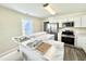 Bright kitchen featuring white cabinetry, stainless steel appliances, and a large island with a countertop at 668 Surl Mount Tirzah Rd, Timberlake, NC 27583