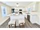 Modern kitchen featuring marble countertops, stainless steel appliances, and barstool seating at 668 Surl Mount Tirzah Rd, Timberlake, NC 27583