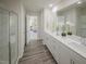 Ensuite bathroom features a dual sink vanity and glass enclosed shower, with an open view to the bedroom at 677 White Birch Ln, Angier, NC 27501