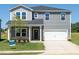 Charming two-story home with gray siding, a two-car garage, and a well-manicured front yard at 677 White Birch Ln, Angier, NC 27501